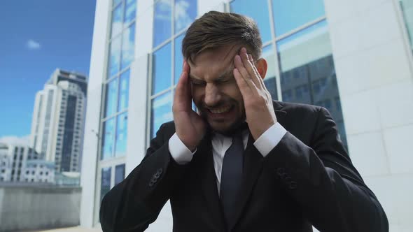 Man in Business Suit Suffering From Headache Attack, Magnetic Storm Response