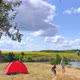 Girl Playing with a Dog Near a Tent on a Beautiful Hill Near River - VideoHive Item for Sale