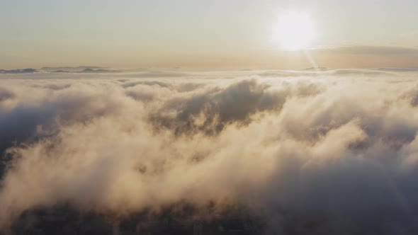 View From a Drone of City Center Above Which Clouds are Rapidly Floating alt