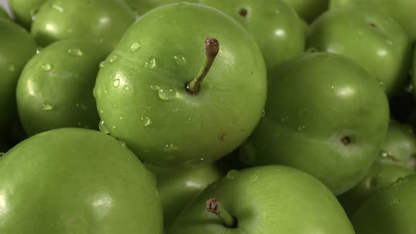 Close Up Pile Of Fresh Green Plum On The Market Counter alt