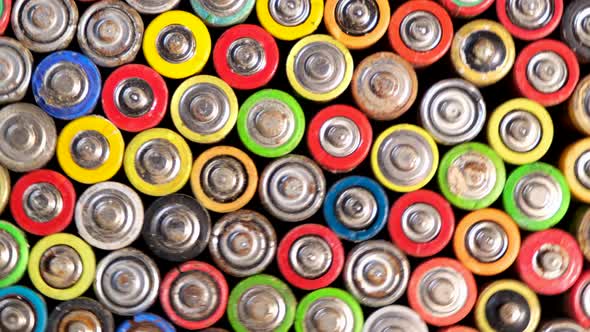 Used batteries rotate on a turntable around its axis. Movement. alt