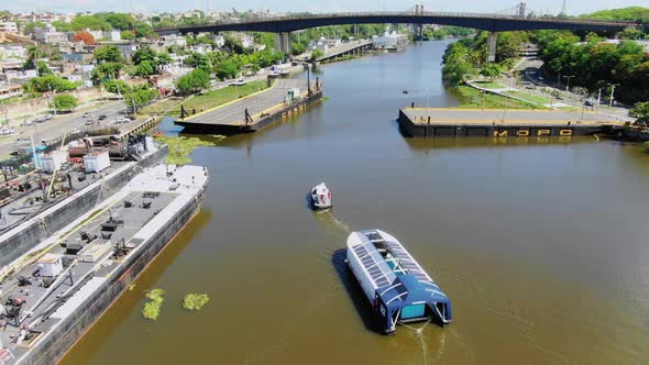 Amazing view of how the solid waste collector interceptor 004 is transported, in the ozama river in alt