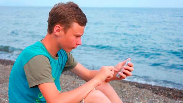 Boy On Beach With Phone 3