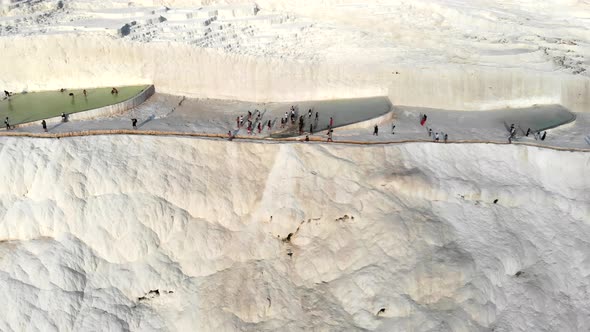 Visitors and Tourist People Walks Pamukkale's Calcium Carbonate Travertines