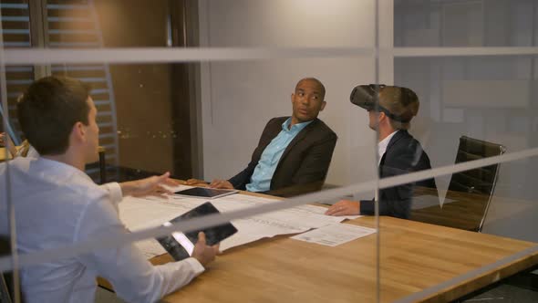Businessman in VR Headset with Colleagues alt