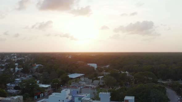 Birds Eye View of Empty and Silent Lane Surrounded with House and Extended Forest During Sunrise on alt