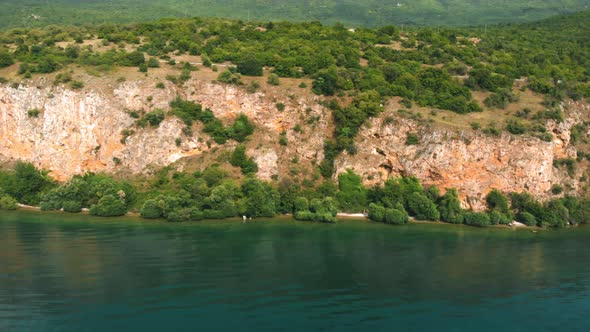 Aerial shot of Macedonia coast. Clif and beautiful water around Ohrid Lake in Southern Europe. alt