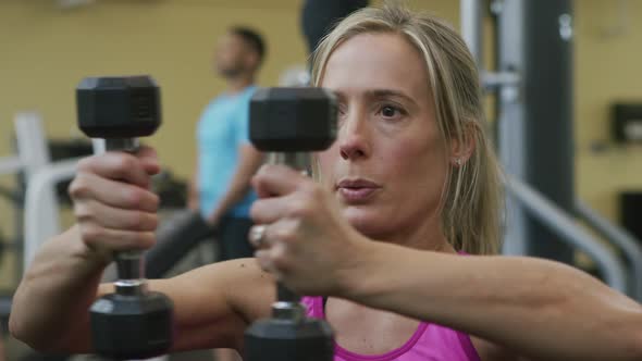 Woman lifting weights at gym