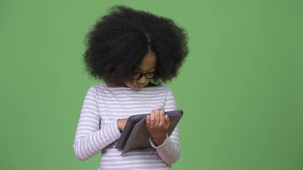Young Cute African Girl with Afro Hair Using Digital Tablet alt