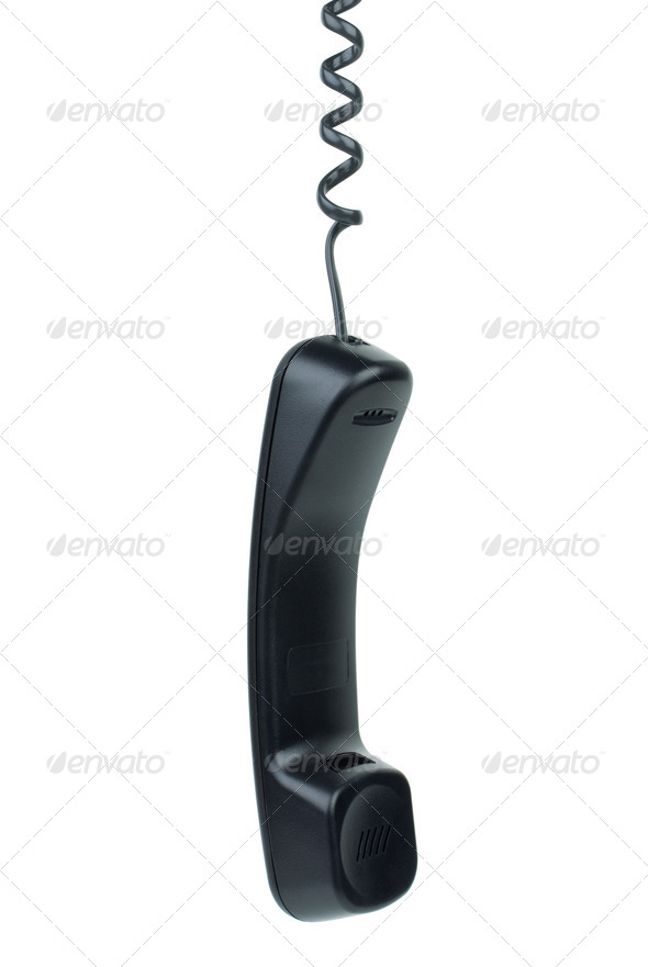 Black phone handset hanging on cord - Stock Photo - Images