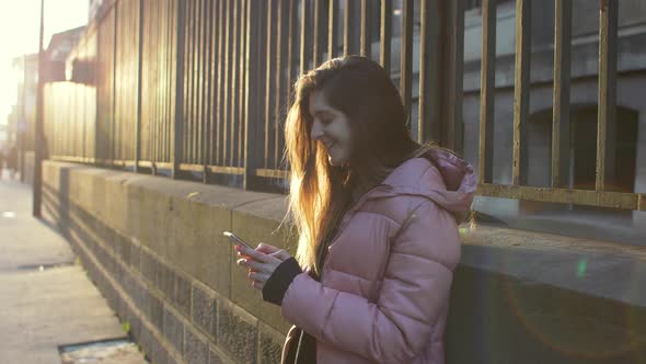 Woman using smartphone in the city alt