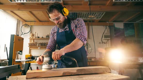 Slow Motion of a Woodworker Polishing a Wooden Block alt