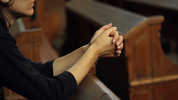 little girl praying in church