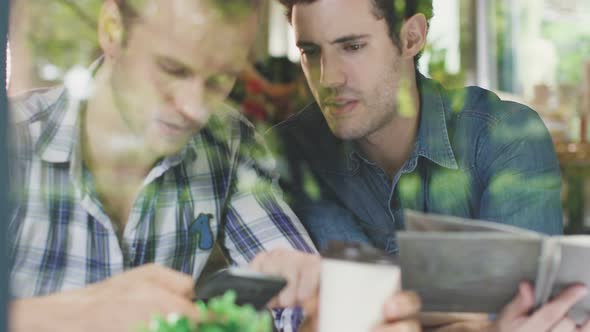 caucasian male friend conversation in cafe alt