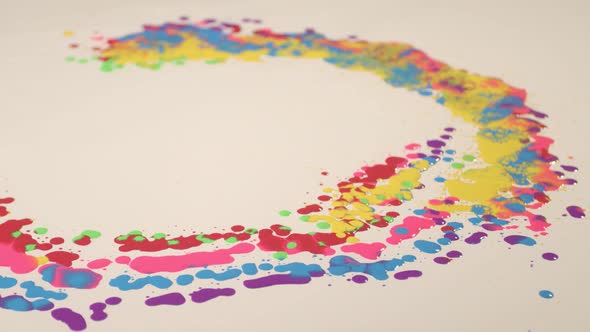 Various colors are dripping on a white background.