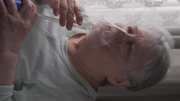 Senior Woman Put on and Breathing with an Oxygen Mask