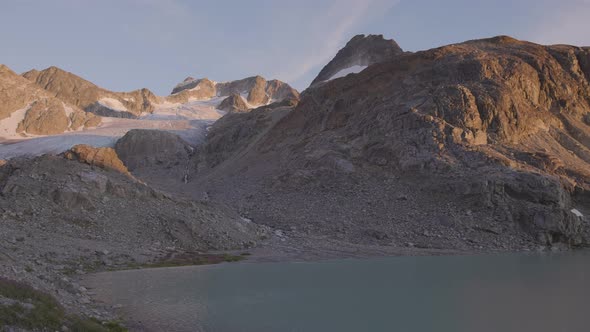 Panoramic View of Vibrant Colorful Glacier Lake Up in Rocky Mountains alt