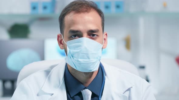 Portrait of a Doctor Wearing a Medicinal Mask and Looking at the Camera alt