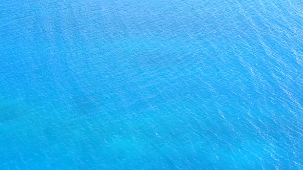 Aerial texture of coastline beach by blue ocean with sand background alt