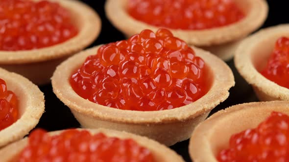Tartlets with red caviar close-up, rotation alt
