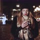 Woman Using Smartphone on European Christmas Market - VideoHive Item for Sale