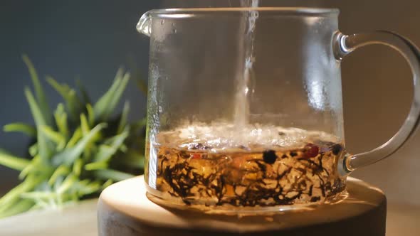 Fragrant Herbal Tea Berries Flower Petals Is Poured Into Transparent Glass Teapot