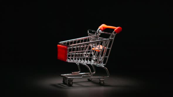 Shopping trolley is rolling to a center of stage
