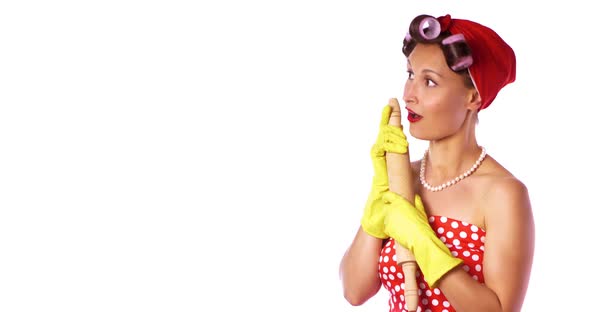 Retro Lady In A Red Dress And A Yellow Household Gloves With A Rolling Pin