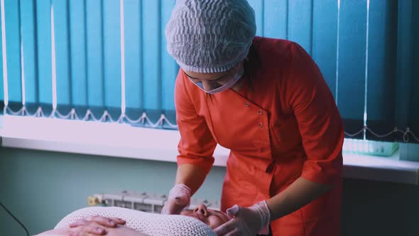 Beautician in Cap Does Massage of Plussize Woman Face alt