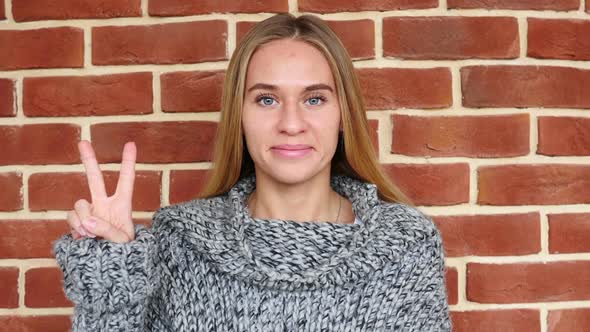 Victory Sign By Woman in Loft Office alt