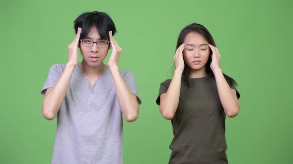 Young Asian Couple Having Headache Together