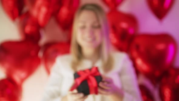 Unrecognizable Woman Shows in Camera Black Velvet Gift Box Red Satin Ribbon alt