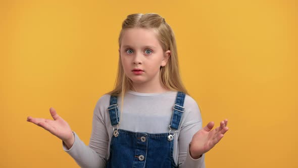 Portrait of Shocked Frustrated Little Girl Gesturing Dont Know Uncertain Posing Isolated on Orange alt