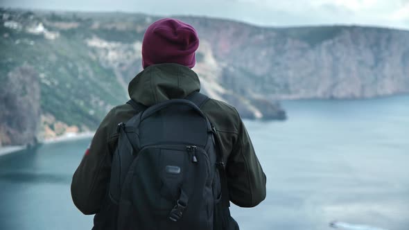 Back View Male Backpacker Enjoying Success Contemplating Sea Scenery From Mountain Top alt
