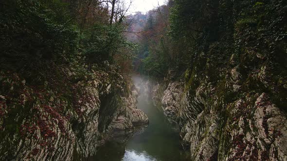Flying Over a River Through a Narrow Canyon with White Rocks Sochi alt