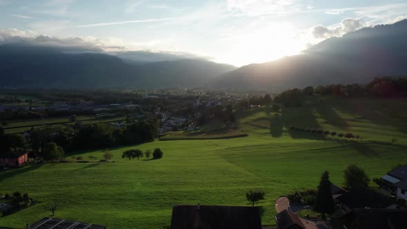 Aerial Landscape View of Ideal Green Fields in Liechtenstein Alps at Sunset alt