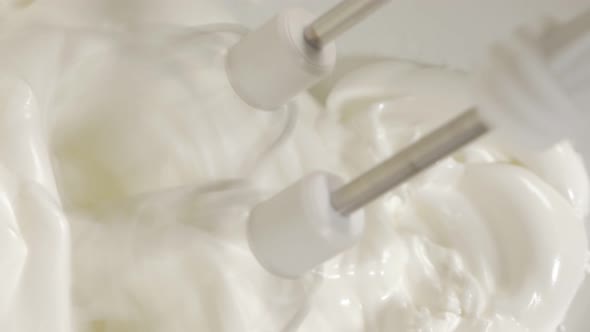Hand mixing egg whites with mixer close-up 4K 2160p UHD footage - Mixing egg whites with electric mi alt