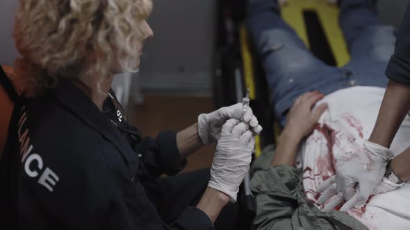 Paramedics Doing Injection and Cardiac Massage for Patient alt