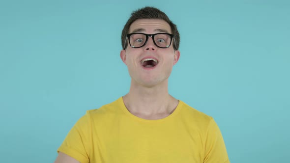 Man Gesturing Thumbs Up, Blue Background alt