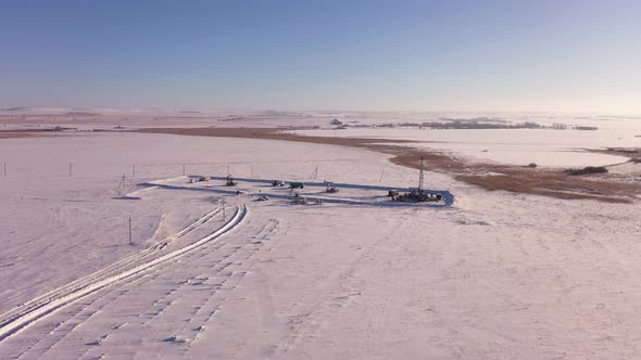 Pump Jack in Vast Oil Fields in Winter alt
