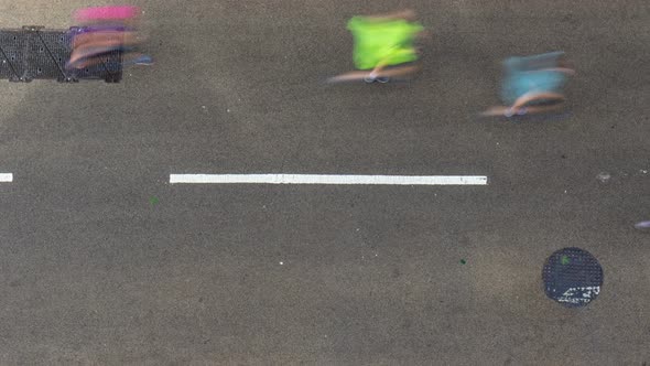 Aerial time lapse view of marathon runners running on tarmacked street alt