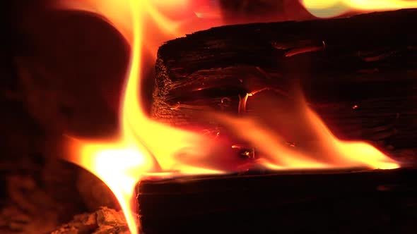 Close up of flaming logs in wood burning stove. UK alt