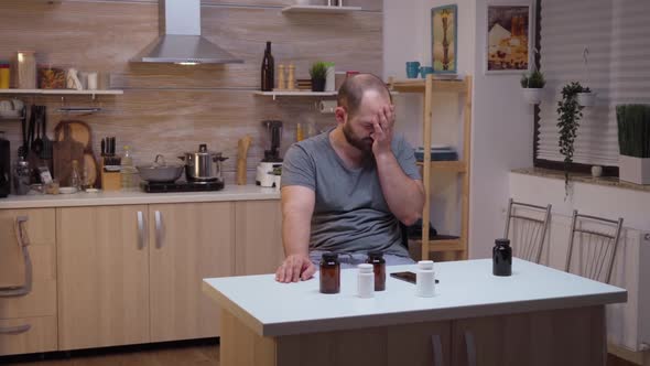 Man with Headache Using Smartphone alt