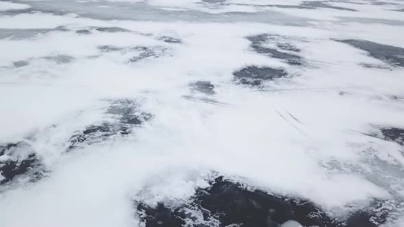 Aerial Drone View Flying High Above Frozen Ice Lake In Winter 4