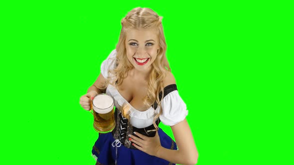 Bavarian Girl with a Glass of Beer in His Hand Flirts. Green Screen alt