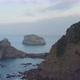 View of Bakio beach, resort city and Gaztelugatxe monastery, north coast of Spain at sunset - VideoHive Item for Sale