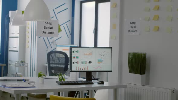 Keep Social Distance Sign Poster on Plastic Separator in Empty Modern Office alt