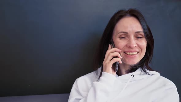 Focused Business Woman Talking on Mobile Phone at Home Office in Slow Motion alt