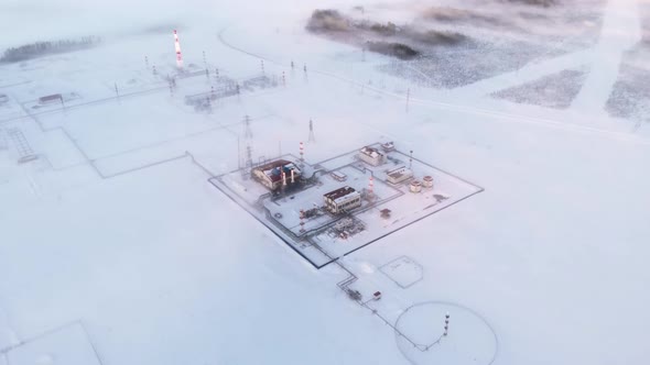 A Drone Flies Over an Oil and Gas Production Facility During Winter Time During Extremely Low alt