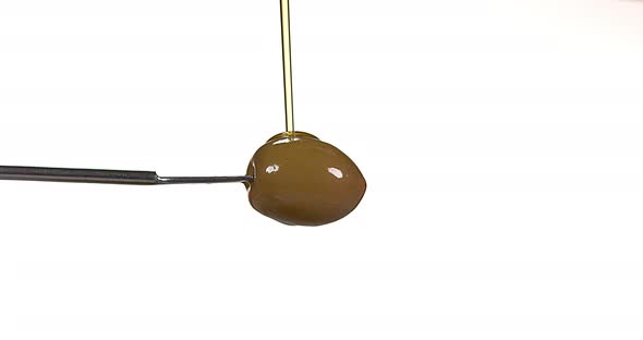 Olive and Olive Oil against White Background, Slow Motion 4K alt